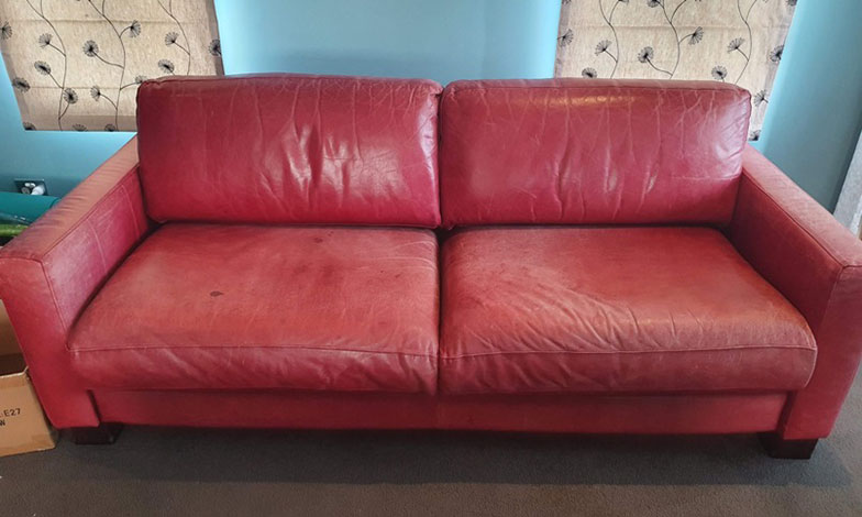 faded red leather sofa
