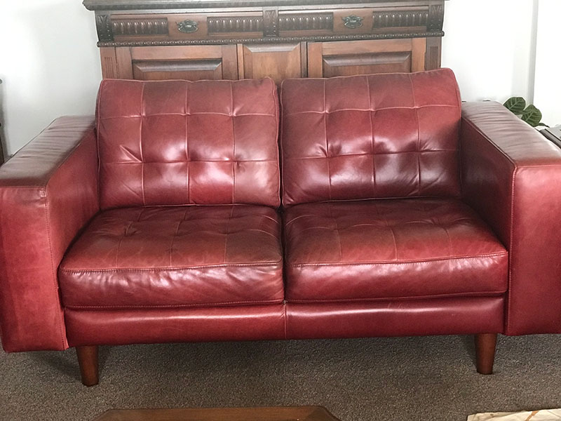 Faded red leather couch