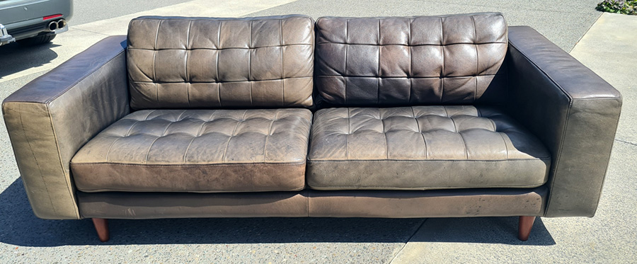Faded black leather couch