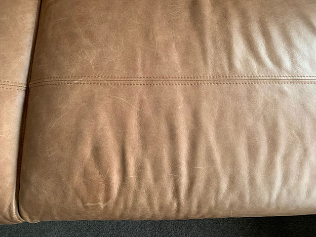 scratched, dry leather couch