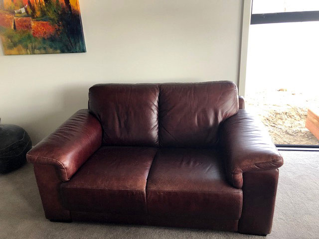 faded red leather couch