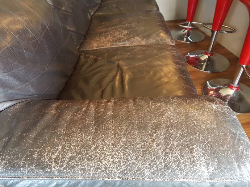 worn out leather couch before