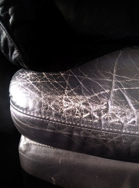 cracked black leather chairs