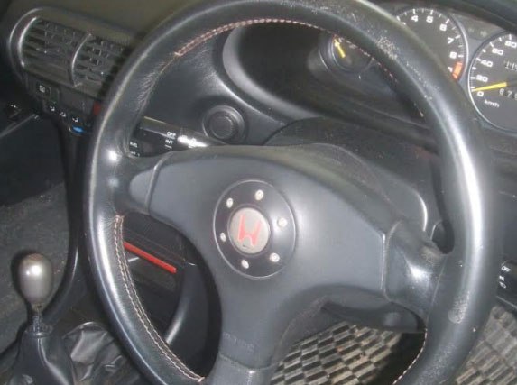 leather steering wheel showing scratches and wear
