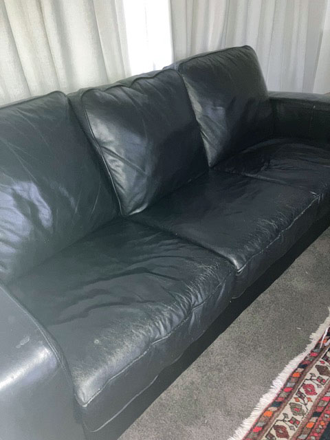 worn black leather couch