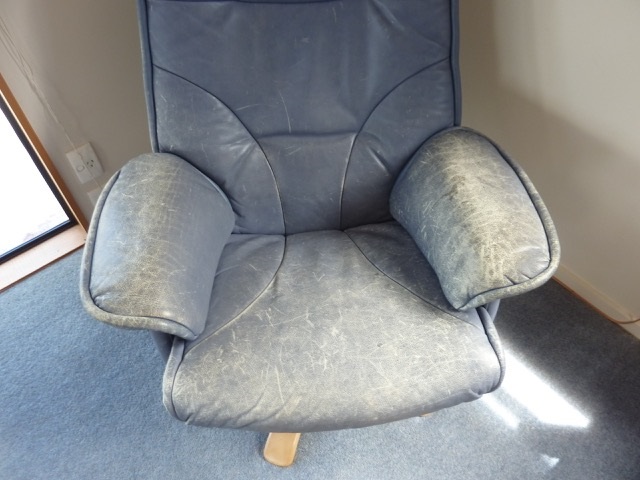 faded chair and footstool before