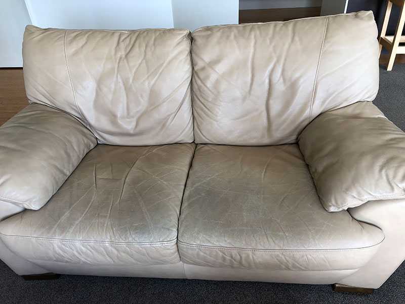 cream leather couch needing work