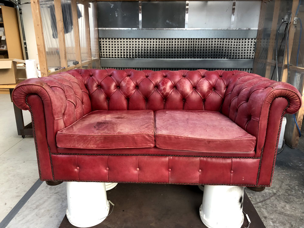 Red leather couch before restoration